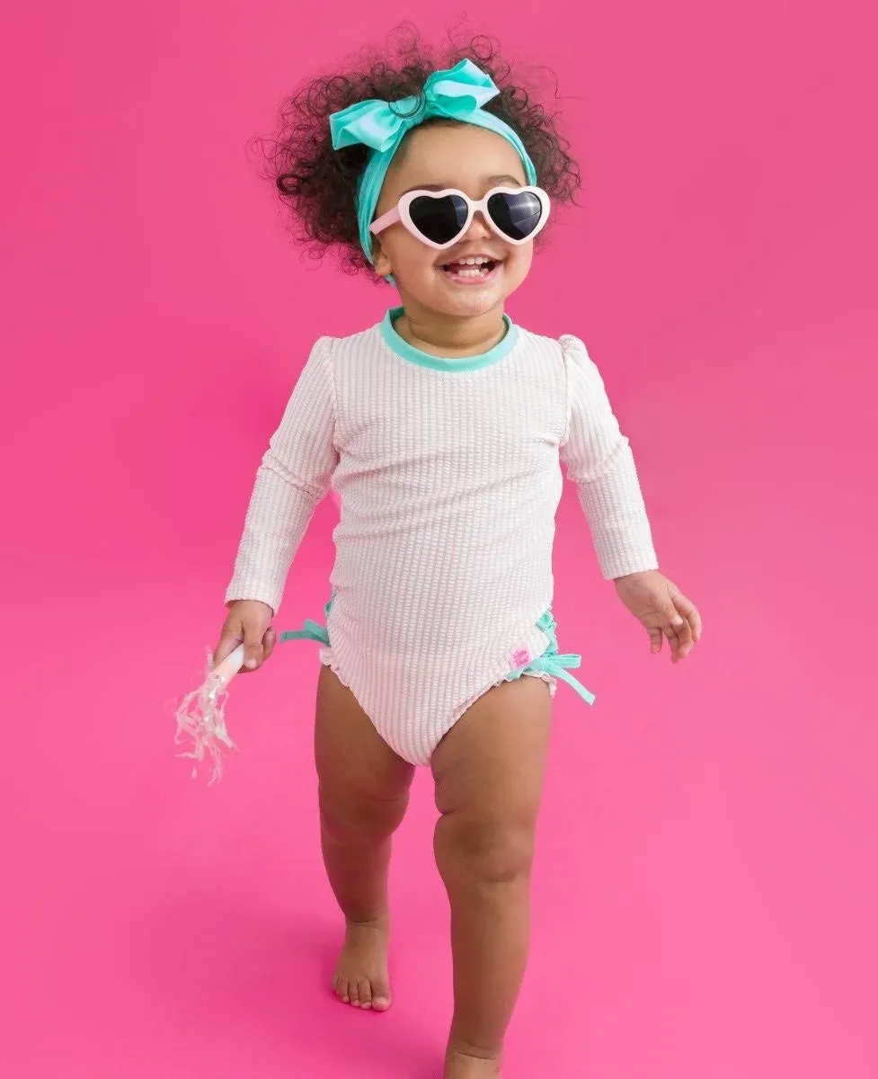 RuffleButts Pink Seersucker Long Sleeve One Piece Rash Guard - 18-24M